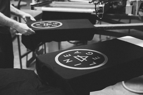 black Lineage shirts on screen printing press