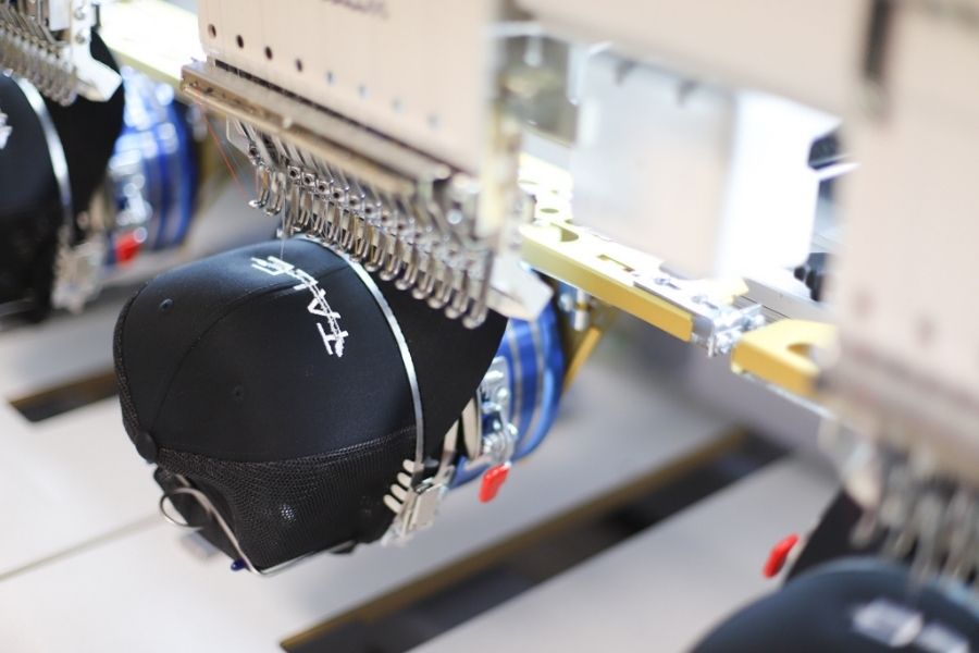 A hat is loaded into the embroidery machine