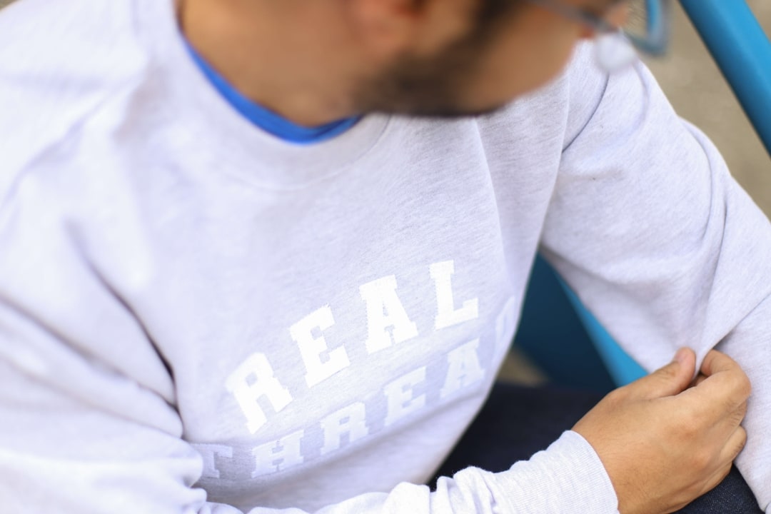 A light gray sweatshirt with white applique and white embroidery