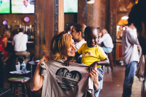 woman and child holding a shirt