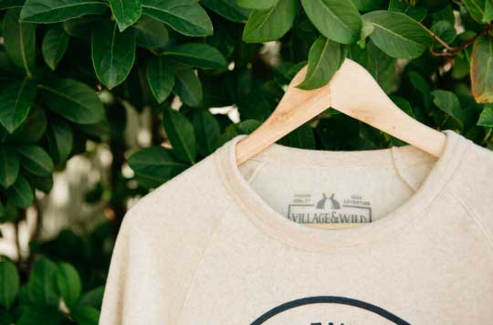 tan shirt hanging on a tree