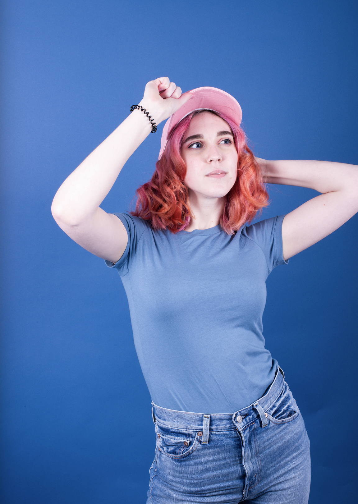 Girl with pink hair and pink hat on a blue background