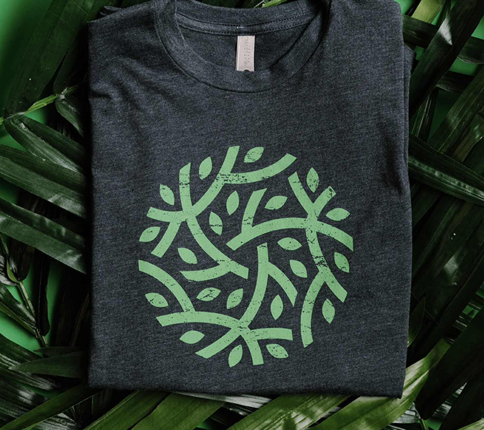 A shirt with a green plant design on the front.